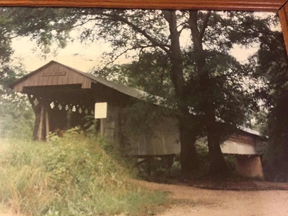 An older framed photo of the Nectar Covered Bridge, summer foliage