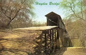 Vintage color postcard labeled 'Hayden Bridge' showing the covered wooden Standridge Bridge spanning the Locust Fork on stone piers