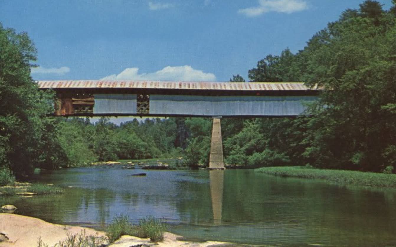 Color postcard from the 1950s showing the full Swann covered bridge crossing the Locust Fork